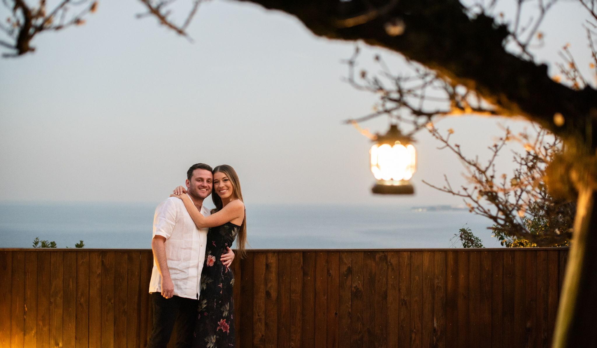 Olivia and Ishay embracing at sunset